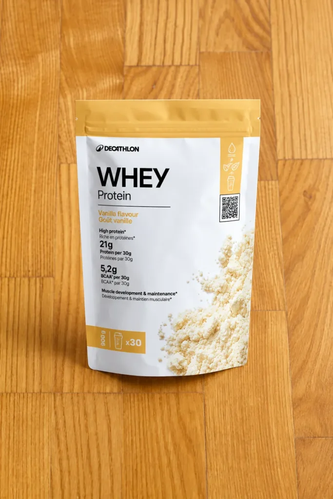 Decathlon Whey Protein vanilla 900 g pouch on a wooden floor